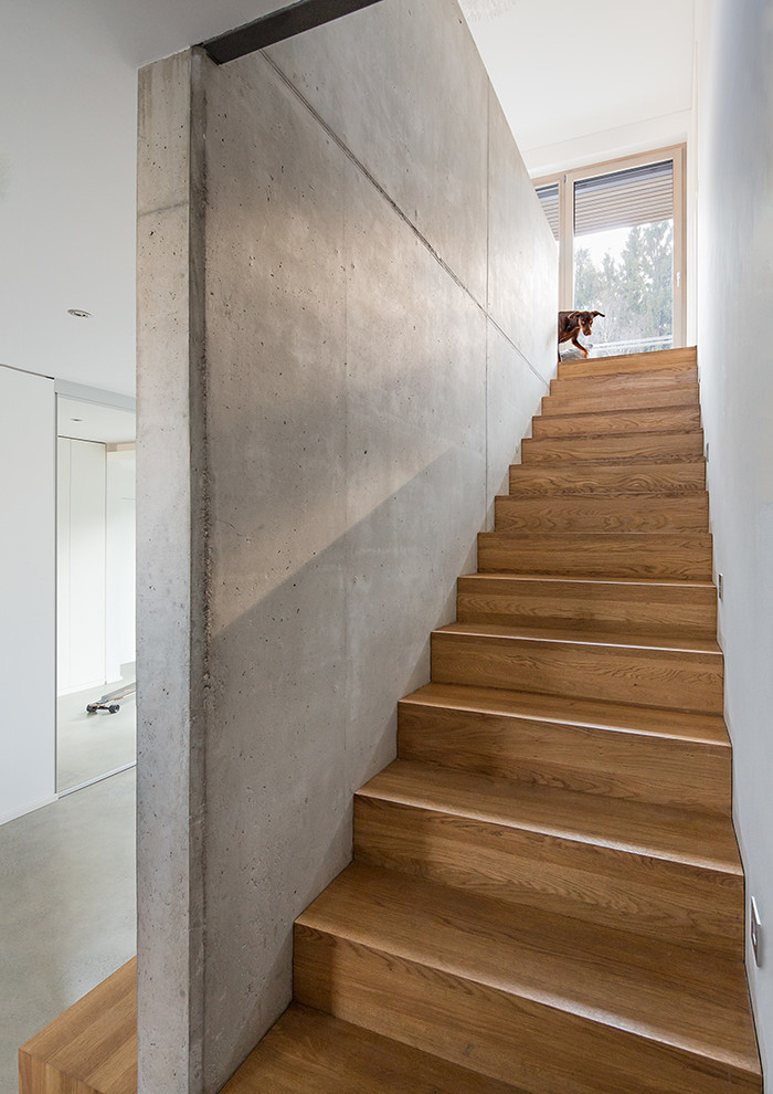 Design ideas for a mid-sized contemporary wood straight staircase in Munich with wood risers.