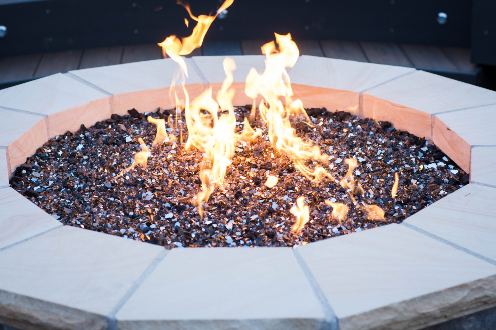 Large transitional backyard deck photo with a fire pit and no cover