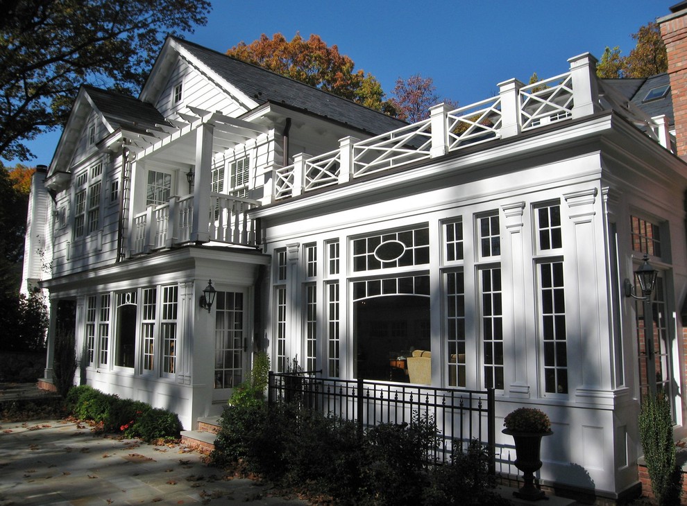 Inspiration for a large traditional two-storey white exterior in New York with wood siding and a gable roof.