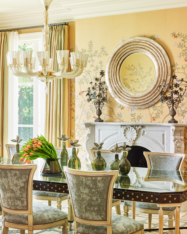 Inspiration for a traditional dining room in Dallas with yellow walls and a standard fireplace.