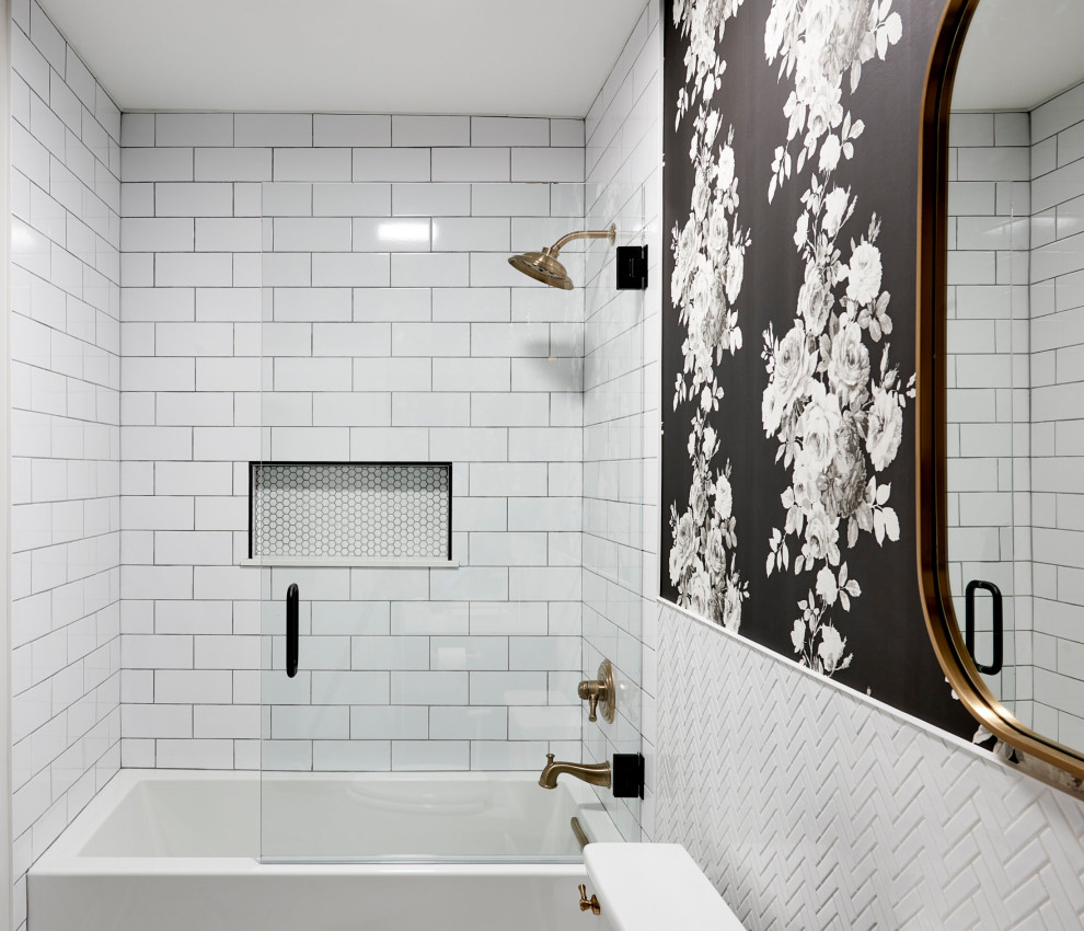 Photo of a small traditional shower room bathroom in Chicago with raised-panel cabinets, black cabinets, an alcove bath, a shower/bath combination, a two-piece toilet, white tiles, porcelain tiles, multi-coloured walls, porcelain flooring, a submerged sink, quartz worktops, grey floors, a hinged door, white worktops, a wall niche, a single sink and a freestanding vanity unit.