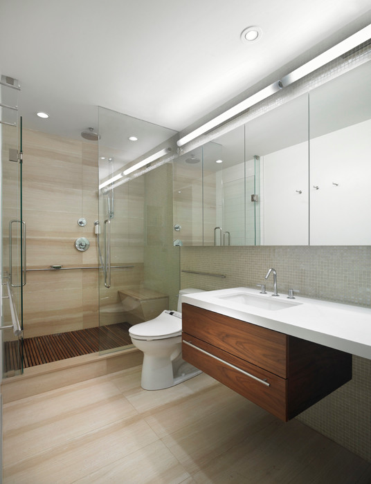Contemporary bathroom in Toronto with flat-panel cabinets, medium wood cabinets, an alcove shower, a one-piece toilet, gray tile, white walls, an undermount sink, beige floor and a hinged shower door.