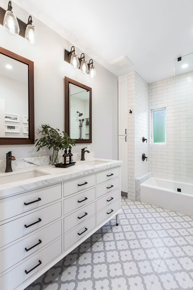 Design ideas for a mid-sized transitional master bathroom in San Francisco with flat-panel cabinets, white cabinets, an alcove tub, a shower/bathtub combo, white tile, ceramic tile, grey walls, porcelain floors, an undermount sink, multi-coloured floor, an open shower and white benchtops.