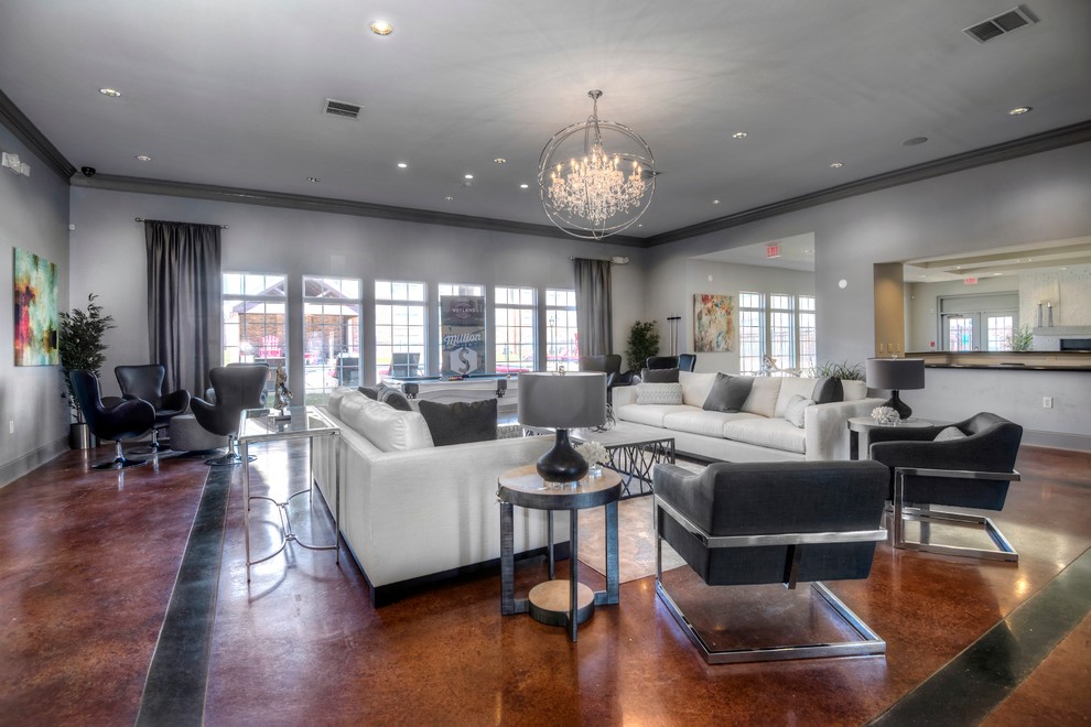 Inspiration for an expansive transitional open concept family room in Houston with a game room, grey walls, concrete floors, no tv and brown floor.