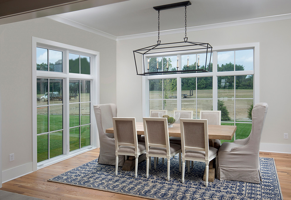 Mid-sized farmhouse light wood floor great room photo in Columbus with gray walls and no fireplace