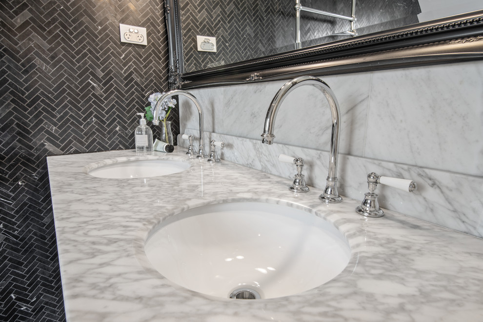 Design ideas for a large contemporary master bathroom in Sydney with furniture-like cabinets, black cabinets, a freestanding tub, a corner shower, a one-piece toilet, black and white tile, ceramic tile, black walls, ceramic floors, an integrated sink, marble benchtops, multi-coloured floor and an open shower.