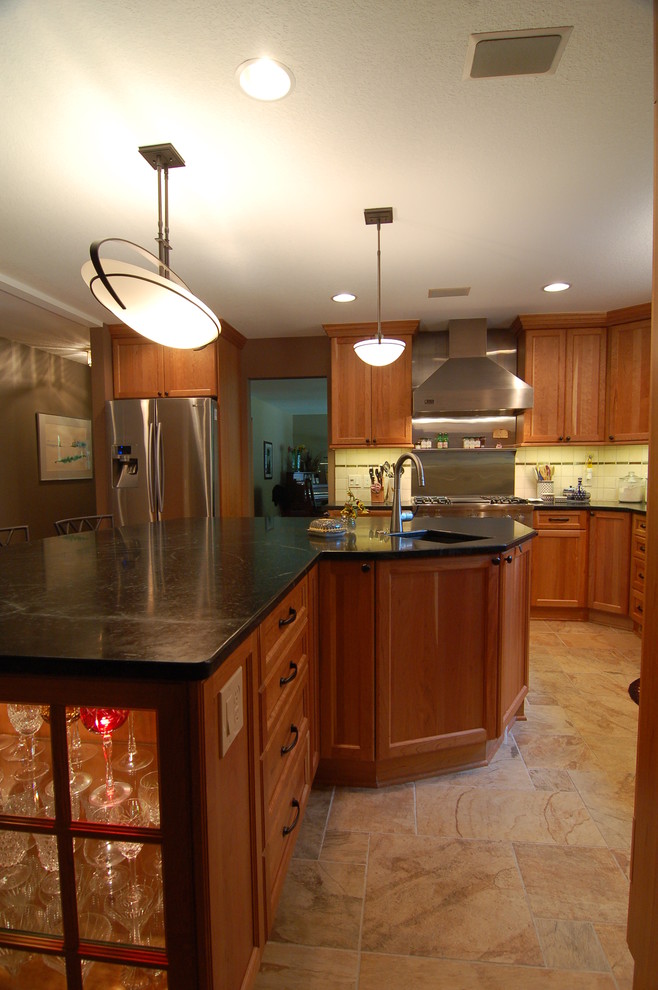 Kitchen - transitional kitchen idea with soapstone countertops, stainless steel appliances and an island