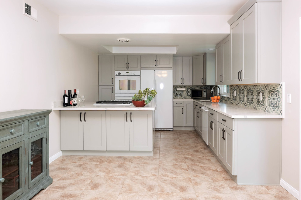 Inspiration for a small traditional l-shaped eat-in kitchen in Los Angeles with a drop-in sink, shaker cabinets, grey cabinets, quartz benchtops, blue splashback, cement tile splashback, white appliances, ceramic floors, no island and pink floor.