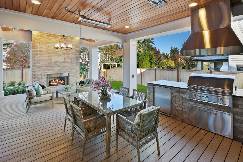 This is an example of a large country backyard verandah in Seattle with decking and a roof extension.
