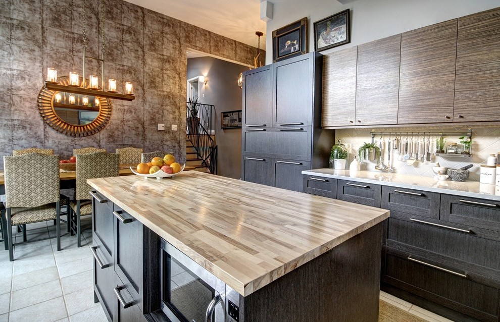 Inspiration for a large contemporary u-shaped eat-in kitchen in Montreal with shaker cabinets, dark wood cabinets, wood benchtops, grey splashback, ceramic splashback, stainless steel appliances, ceramic floors and with island.