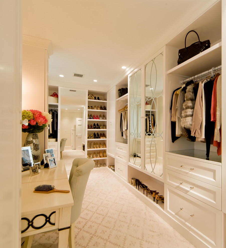 Inspiration for a large traditional women's dressing room in DC Metro with recessed-panel cabinets, white cabinets and carpet.