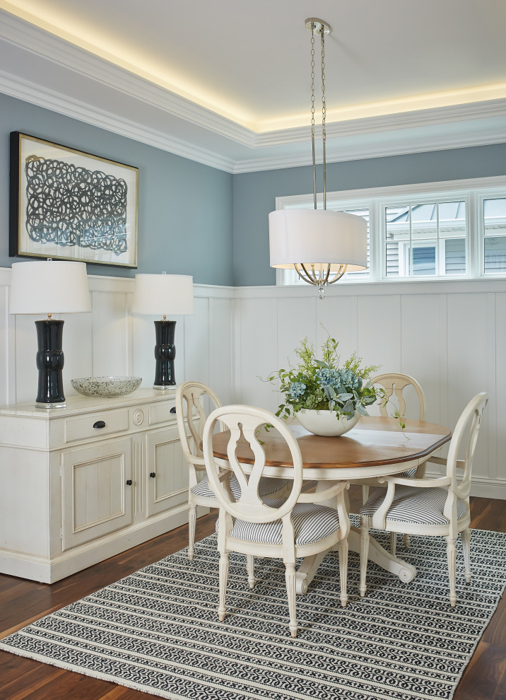 Photo of a mid-sized beach style dining room in Grand Rapids with blue walls, recessed, dark hardwood floors, brown floor and decorative wall panelling.