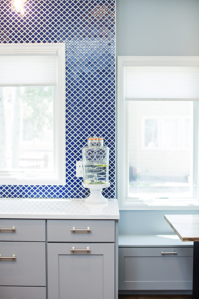 Eat-in kitchen - huge transitional u-shaped eat-in kitchen idea in Denver with shaker cabinets, gray cabinets, quartz countertops, blue backsplash, no island and white countertops