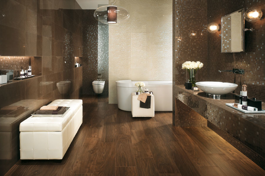 Inspiration for a large contemporary master bathroom in Denver with a vessel sink, tile benchtops, a freestanding tub, a wall-mount toilet, brown tile, porcelain tile, brown walls, dark hardwood floors and brown floor.