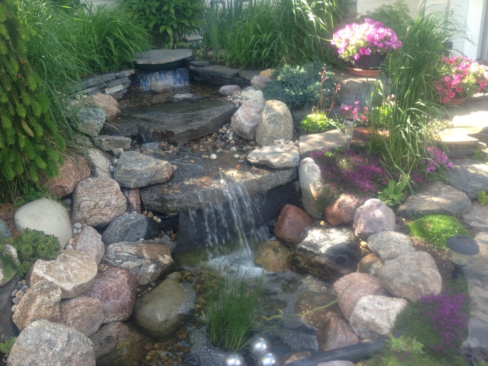 This is an example of a small rustic partial sun front yard formal garden in Calgary for summer.