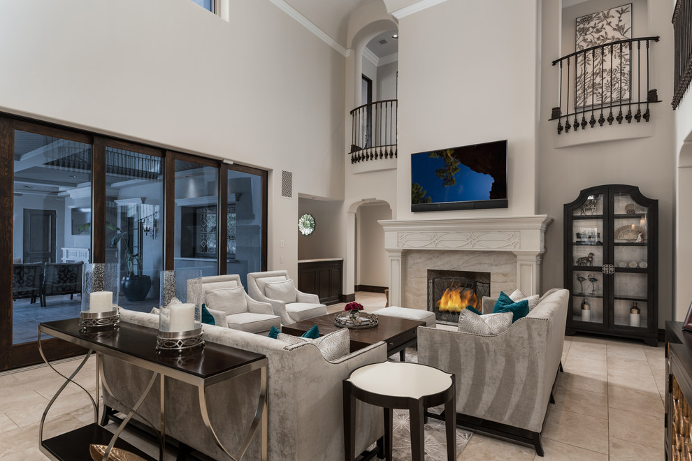 Expansive mediterranean open concept family room in Phoenix with white walls, marble floors, a standard fireplace, a stone fireplace surround, no tv, multi-coloured floor, coffered and panelled walls.