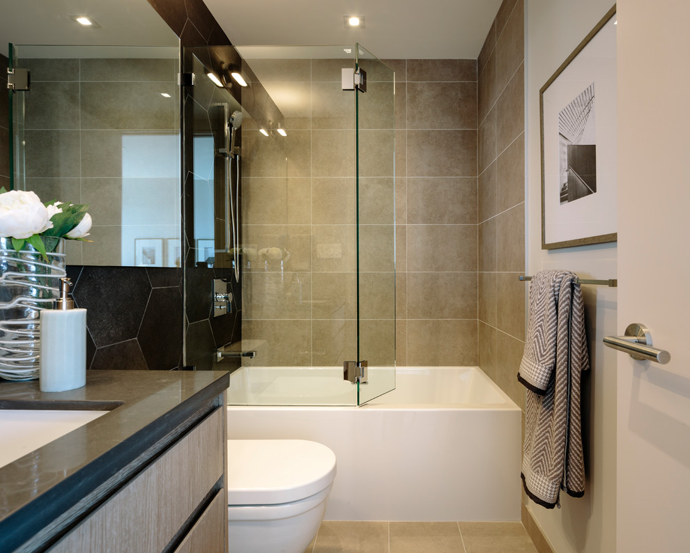 Photo of a large contemporary master bathroom in Vancouver with flat-panel cabinets, medium wood cabinets, an alcove tub, a shower/bathtub combo, a wall-mount toilet, beige tile, porcelain tile, beige walls, porcelain floors, a vessel sink, engineered quartz benchtops, beige floor, a hinged shower door and grey benchtops.