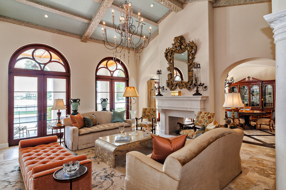 This is an example of a mediterranean open concept living room in Miami with beige walls, a two-sided fireplace and a stone fireplace surround.