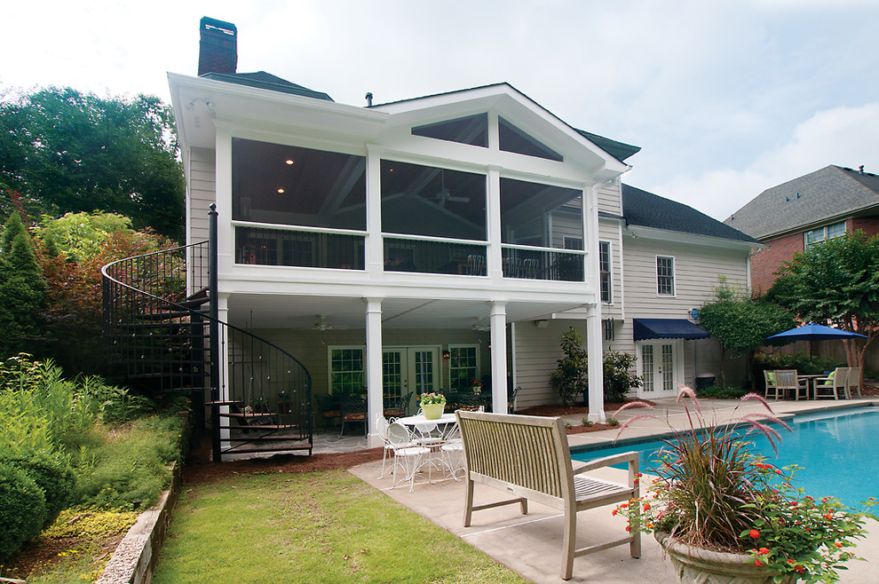 This is an example of a large transitional backyard verandah in Atlanta with a roof extension.