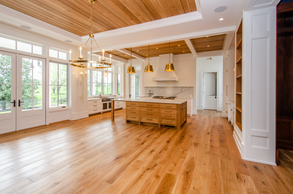 Inspiration for an expansive country kitchen in DC Metro with shaker cabinets, light wood cabinets, quartz benchtops, white splashback, engineered quartz splashback, coloured appliances, light hardwood floors, with island, white benchtop and coffered.