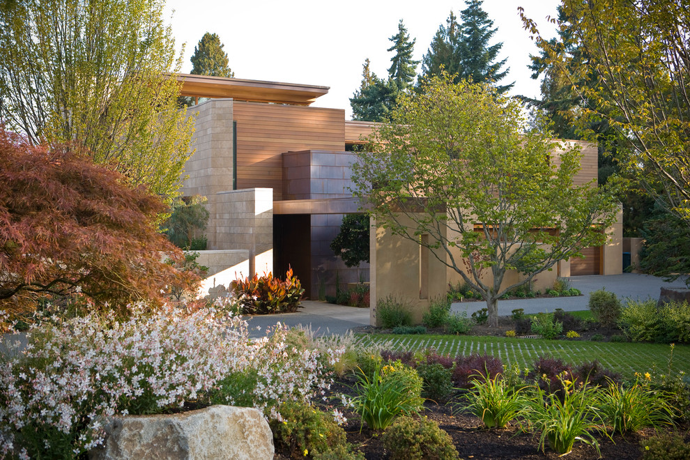 Inspiration for a large contemporary two-storey beige exterior in Seattle with mixed siding and a flat roof.