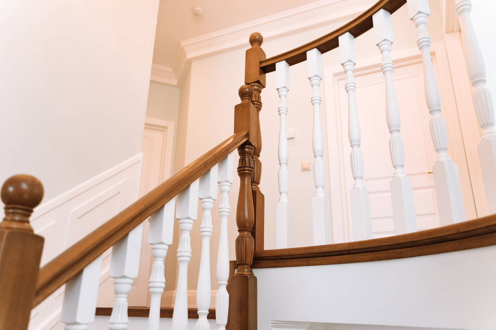 Inspiration for a large timeless wooden u-shaped wood railing and wall paneling staircase remodel in Moscow with wooden risers
