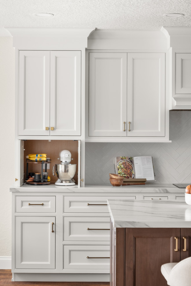 Kitchen - transitional kitchen idea in Orlando with white cabinets, quartzite countertops, gray backsplash, ceramic backsplash, an island and white countertops