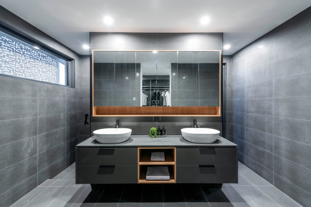 Photo of a mid-sized contemporary 3/4 bathroom in Canberra - Queanbeyan with flat-panel cabinets, grey cabinets, an open shower, gray tile, cement tile, cement tiles, a console sink, engineered quartz benchtops, grey floor, an open shower and grey benchtops.