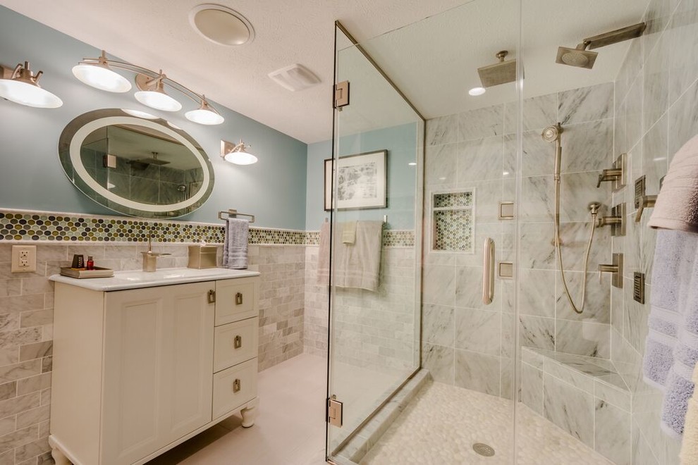 Inspiration for a mid-sized transitional 3/4 bathroom in Chicago with white cabinets, a corner shower, white tile, blue walls, porcelain floors, recessed-panel cabinets, a two-piece toilet, subway tile, a console sink and solid surface benchtops.