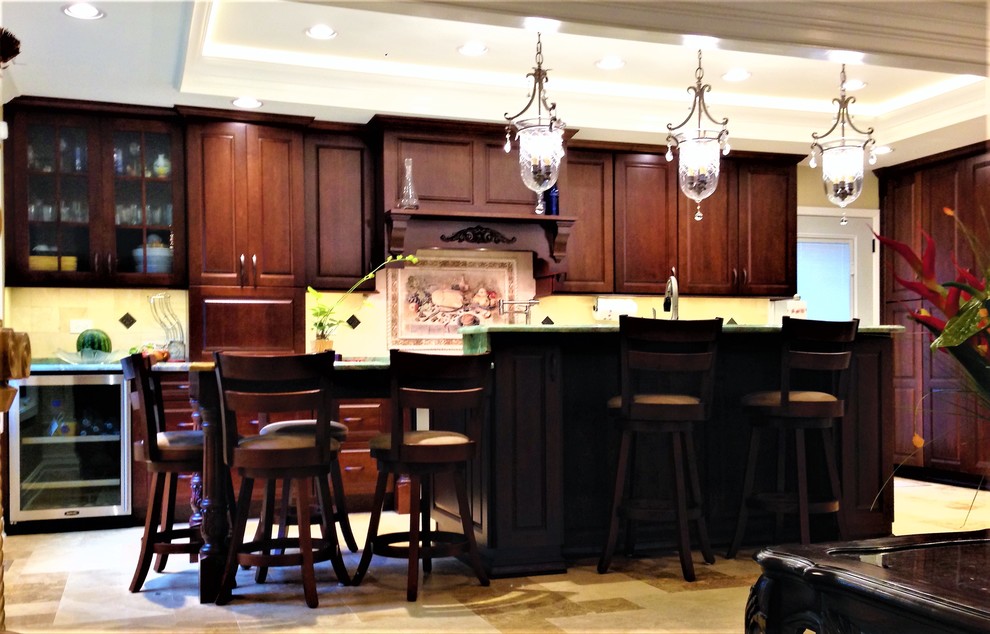 Mid-sized transitional travertine floor and beige floor eat-in kitchen photo in Chicago with a double-bowl sink, raised-panel cabinets, dark wood cabinets, quartzite countertops, beige backsplash, stone tile backsplash, stainless steel appliances and an island