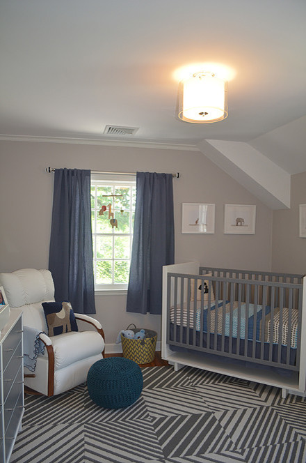 Design ideas for a mid-sized transitional nursery for boys in Other with grey walls and dark hardwood floors.
