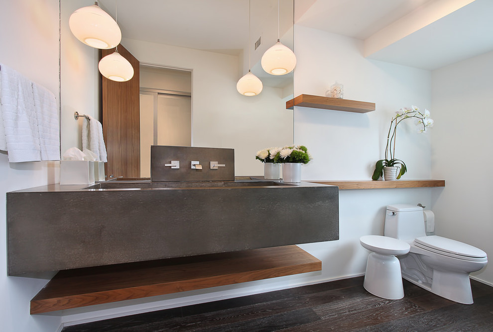 Contemporary powder room in Orange County with concrete benchtops, white walls, a trough sink and grey benchtops.