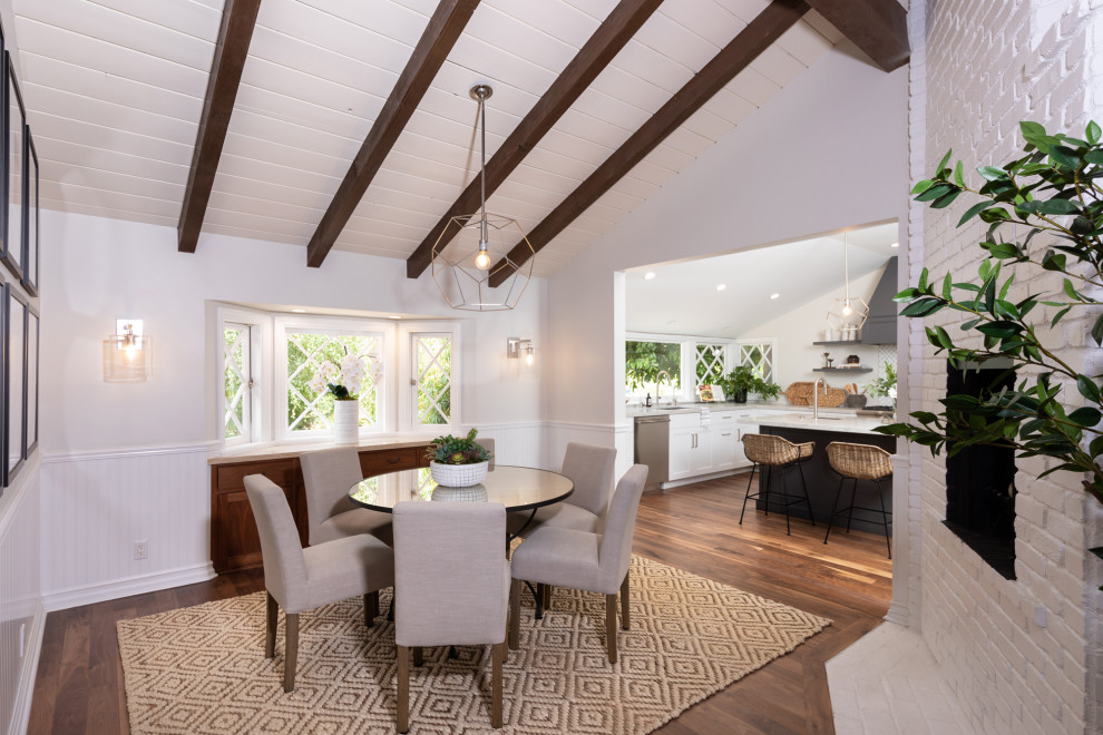 Large beach style kitchen/dining combo in Los Angeles with dark hardwood floors, brown floor and vaulted.