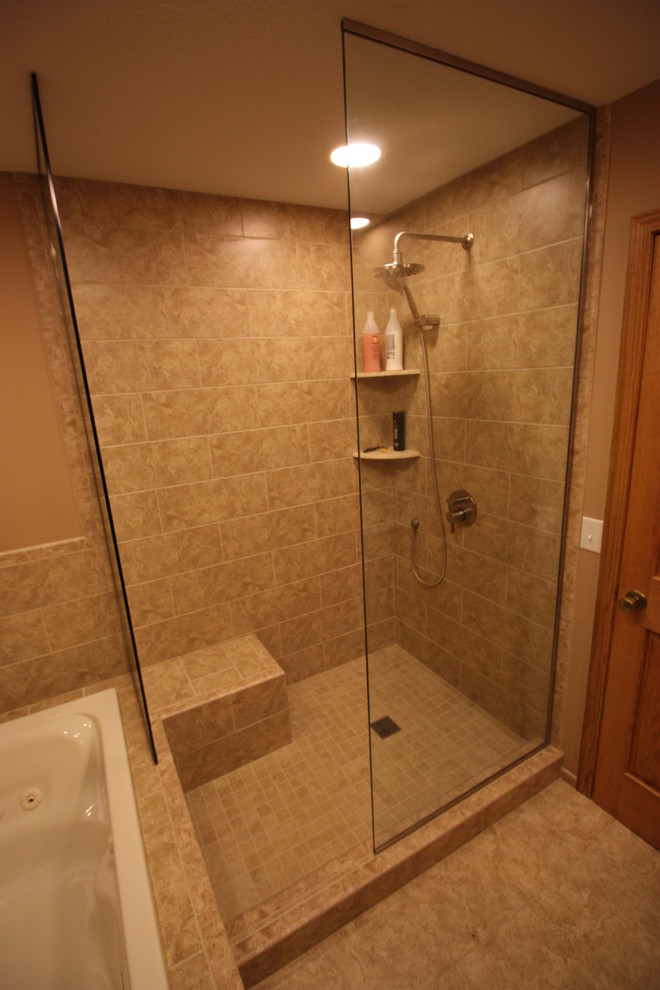 Photo of a mid-sized transitional master bathroom in Minneapolis with an undermount sink, raised-panel cabinets, medium wood cabinets, granite benchtops, a drop-in tub, an open shower, a two-piece toilet, beige tile, ceramic tile, beige walls and ceramic floors.