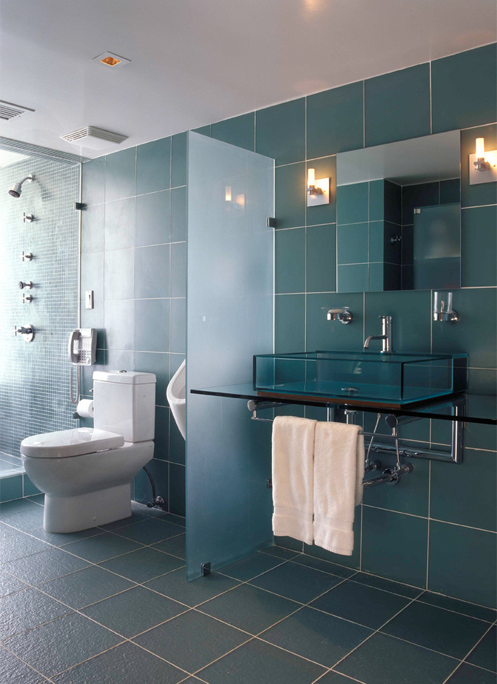 Photo of a large contemporary master bathroom in Miami with flat-panel cabinets, an alcove shower, a two-piece toilet, blue tile, blue walls, a vessel sink and a hinged shower door.