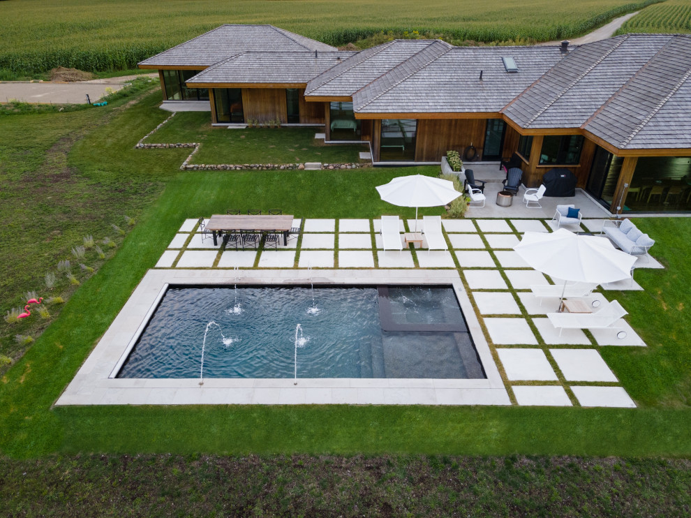 Imagen de piscina contemporánea pequeña rectangular en patio trasero con paisajismo de piscina y losas de hormigón