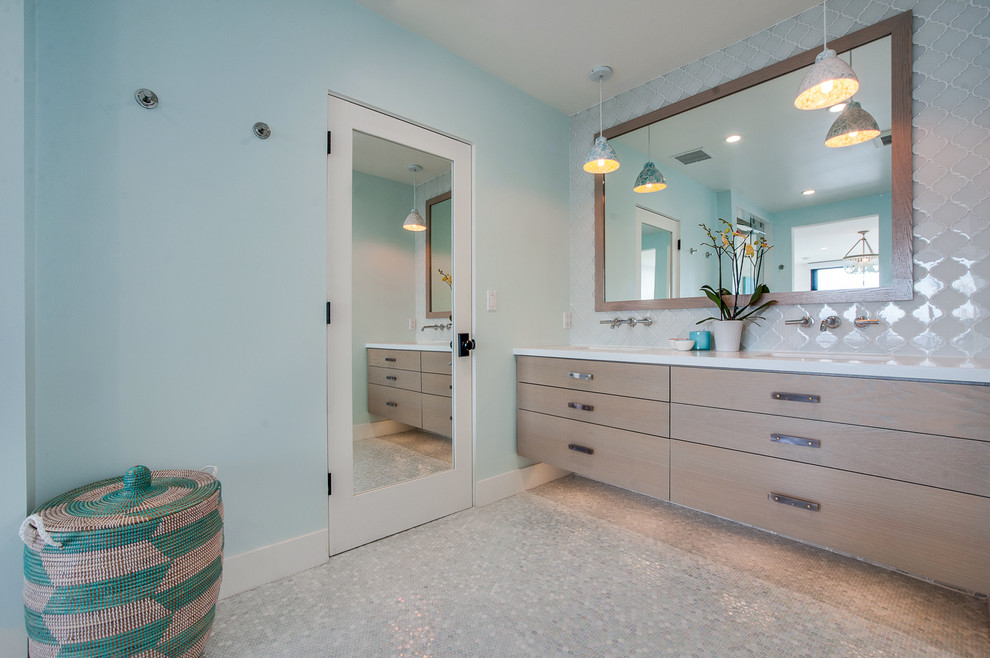 Inspiration for a beach style master wet room bathroom in Los Angeles with flat-panel cabinets, light wood cabinets, a corner tub, glass sheet wall, blue walls, a drop-in sink and engineered quartz benchtops.