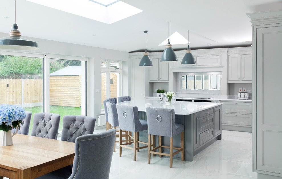 Large transitional l-shaped open plan kitchen in Other with an undermount sink, shaker cabinets, grey cabinets, quartzite benchtops, mirror splashback, stainless steel appliances, porcelain floors, with island and grey floor.