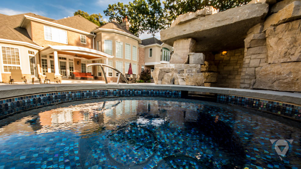 Large mountain style backyard stone and rectangular natural pool fountain photo in Chicago