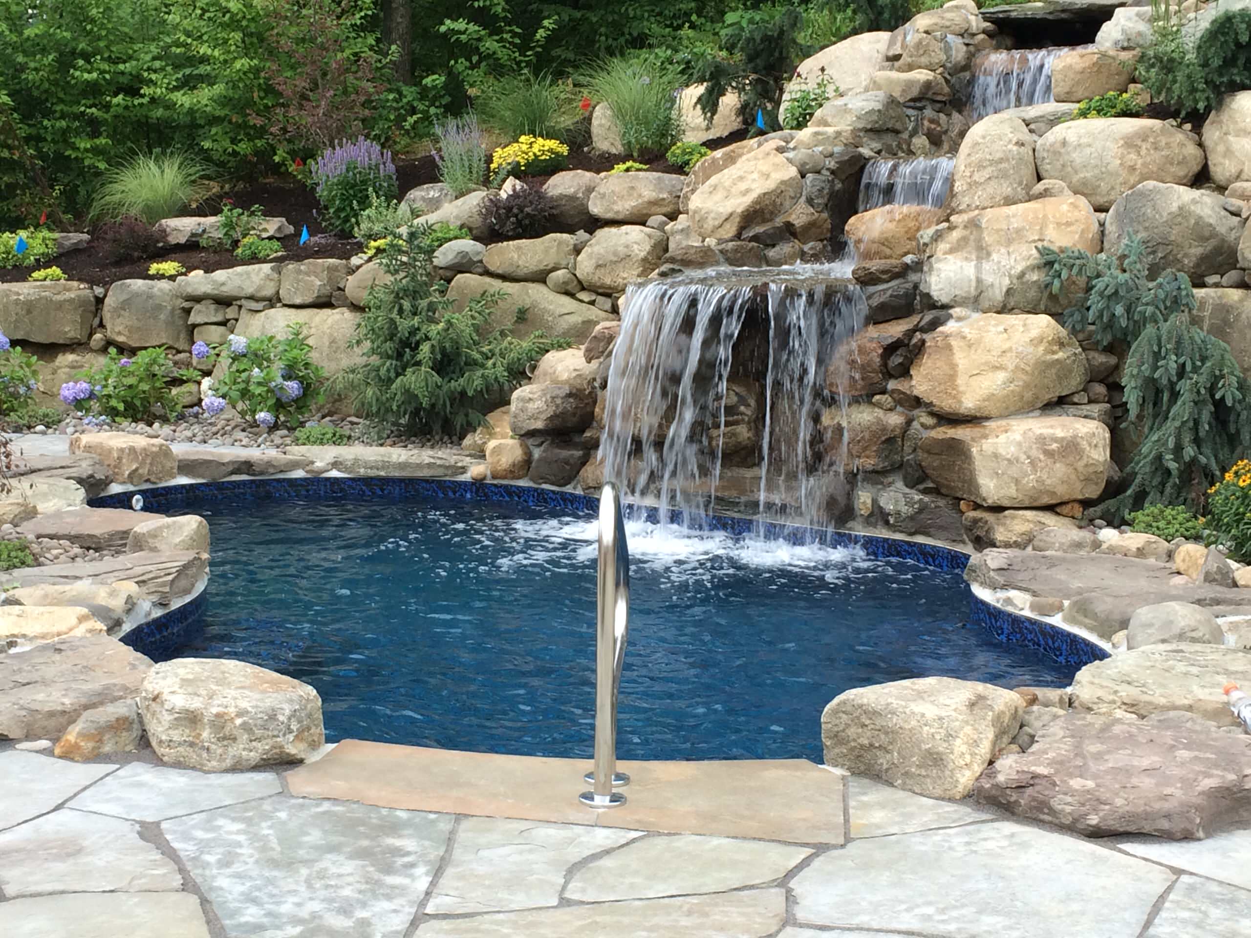 pool with natural bluestone patio natural waterfall and landscape