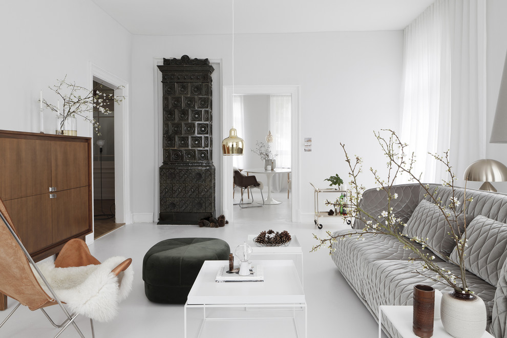 Inspiration for a scandinavian enclosed living room in Frankfurt with white walls and a tile fireplace surround.