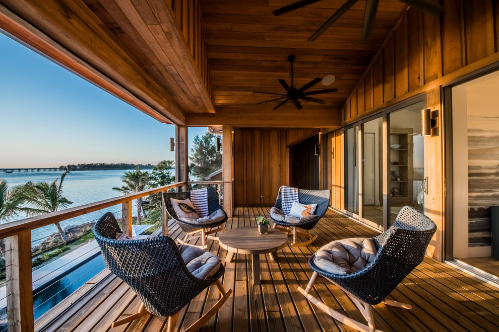 Huge island style deck photo in Tampa with a roof extension
