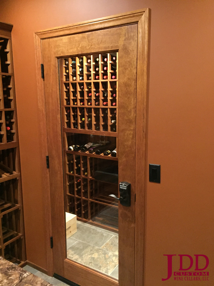 Photo of a mid-sized traditional wine cellar in Cincinnati with porcelain floors and storage racks.