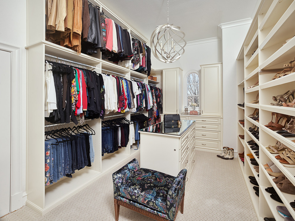 Mediterranean women's storage and wardrobe in Dallas with beige cabinets, carpet and beige floor.