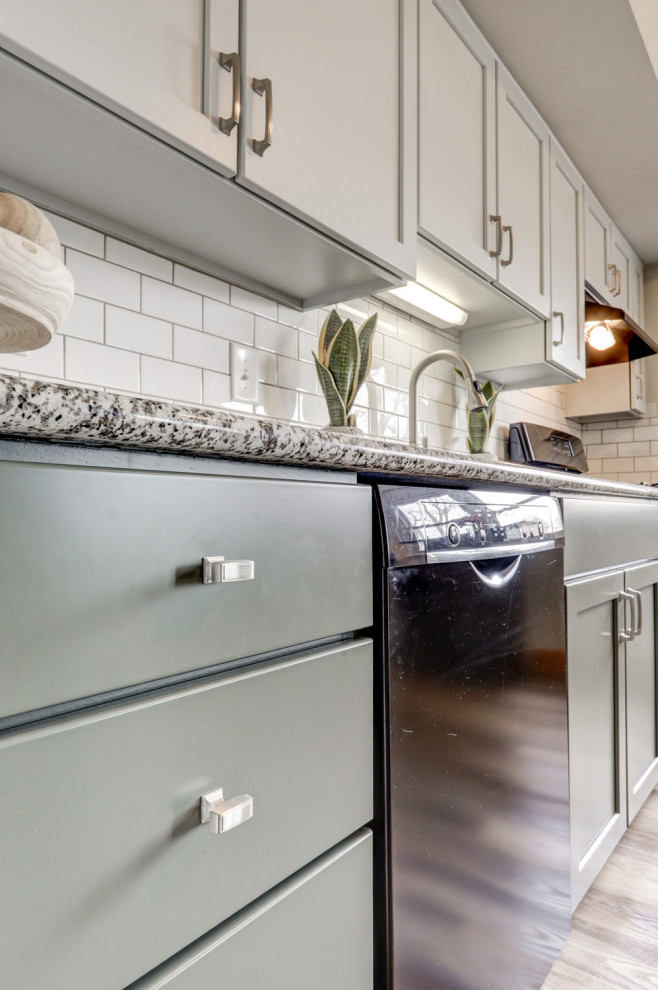 Example of a mid-sized transitional l-shaped eat-in kitchen design with recessed-panel cabinets, green cabinets and a peninsula