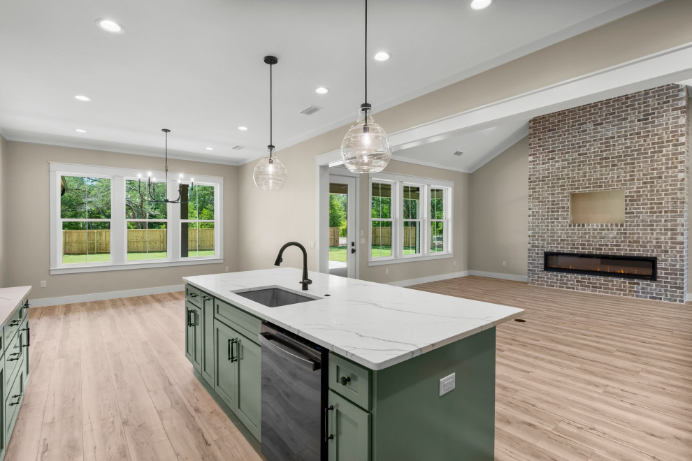 Inspiration for a large craftsman l-shaped vinyl floor and beige floor open concept kitchen remodel with an undermount sink, shaker cabinets, green cabinets, quartzite countertops, beige backsplash, porcelain backsplash, stainless steel appliances, an island and white countertops