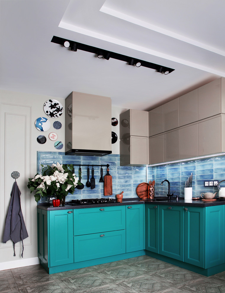 Mid-sized transitional l-shaped separate kitchen in Other with recessed-panel cabinets, blue splashback, a double-bowl sink, turquoise cabinets, solid surface benchtops, ceramic splashback, ceramic floors, no island, grey floor and grey benchtop.