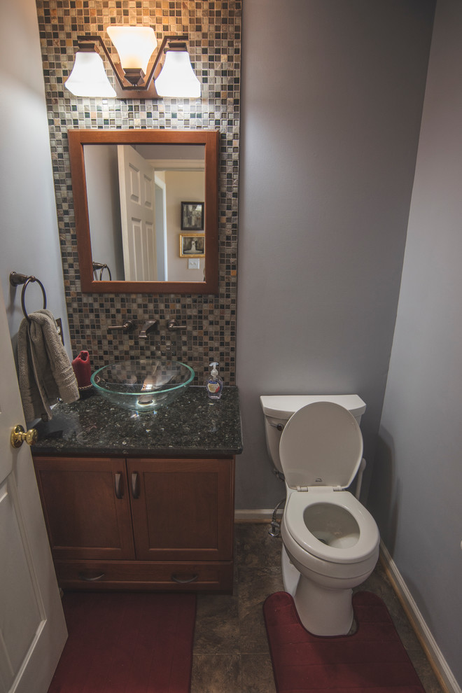 Design ideas for a small 3/4 bathroom in New York with recessed-panel cabinets, dark wood cabinets, a wall-mount toilet, brown tile and blue walls.