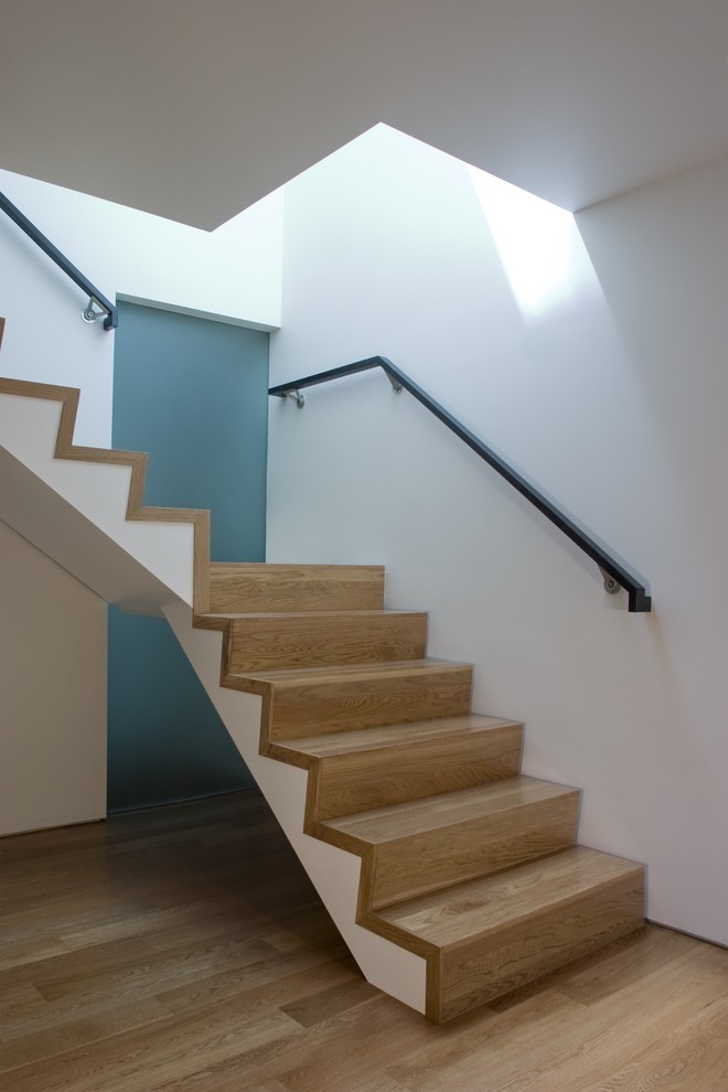 Contemporary wood staircase in San Francisco with wood risers.