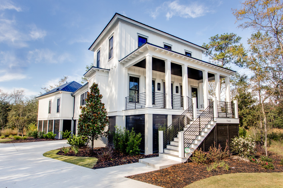 Design ideas for a contemporary two-storey white exterior in Charleston.